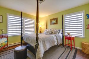 a bedroom with a bed and two windows at New Jersey Home - Deck, Grill and Walkable to Beach! in Ship Bottom