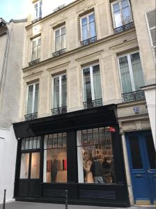 a store front of a building with windows at Marais Studio with Mezzanine in Paris