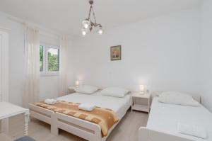Postel nebo postele na pokoji v ubytování Apartments Family Gligora
