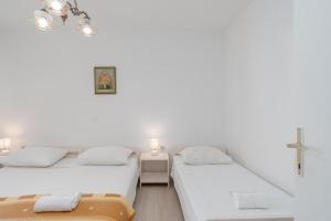 Postel nebo postele na pokoji v ubytování Apartments Family Gligora