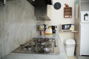a kitchen with a stove and a counter top at Guest House Manara in Reggio Emilia