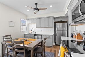 a kitchen with a table and chairs and a refrigerator at New Juliette St in Boston
