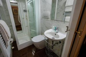 a bathroom with a toilet and a sink and a shower at Acacia Firenze - Adelfa in Florence