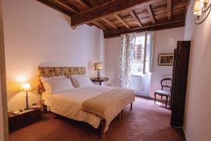 a bedroom with a large bed and a window at Acacia Firenze - Adelfa in Florence
