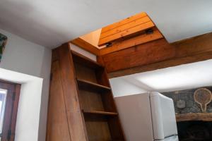 a room with wooden shelves and a ceiling at Unique House - Pool, Terrace & Amazing View in Ribeira Brava