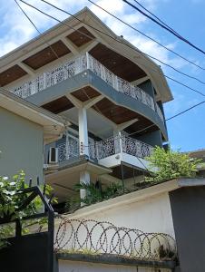 a house with a balcony on top of it at Himma's Apartments in Adonkia