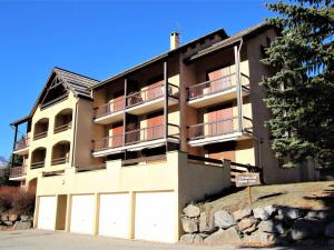 a building with two garage doors in front of it at Appartement La Salle-les-Alpes, 3 pièces, 7 personnes - FR-1-330F-22 in Serre Chevalier