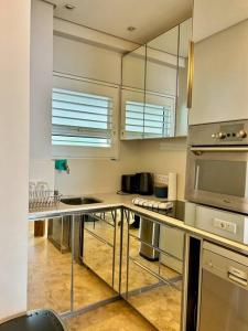 a kitchen with stainless steel counter tops and appliances at Clifton Beach Apartment in Cape Town