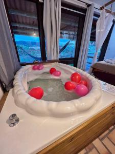 a bath tub with cherries in it in a room at Pousada Sonho do Vale in Praia do Rosa