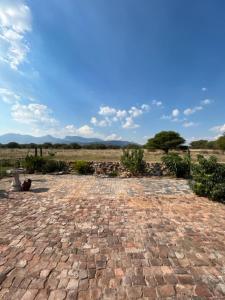 a stone walkway in the middle of a field at Vanross Bushveld Self Catering Accommodation in Maraheki