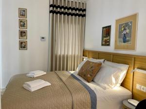 a bedroom with a bed with two towels on it at Casa Divina in Veria