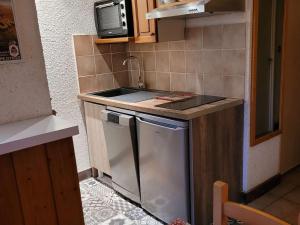 a small kitchen with a sink and a dishwasher at Appartement Huez, 1 pièce, 4 personnes - FR-1-405-11 in L'Alpe-d'Huez