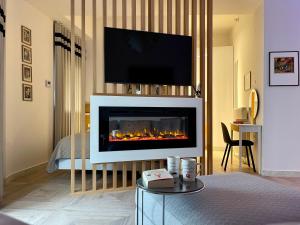 a living room with a fireplace with a tv above it at Casa Divina in Veria