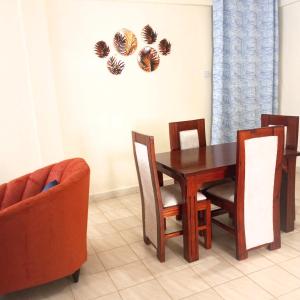 a dining room with a table and two chairs at Miguel's haven, Homely vibes! in Kakamega