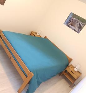 a bed in a room with a blue mattress at Les Ecureuils "Les Faons" in Roubion