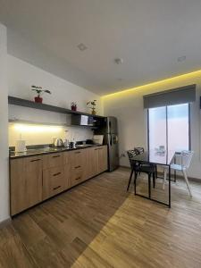 a kitchen with a table and a dining room at Kiran Lodging Guayaquil in Guayaquil