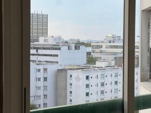 a view of a city skyline from a window at Appartement 3 Chambres Evry plein Centre ville in Évry-les-Châteaux