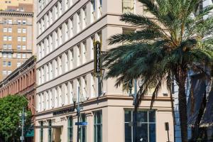 a building with a palm tree in front of it at Fairfield Inn & Suites by Marriott New Orleans Downtown/French Quarter Area in New Orleans