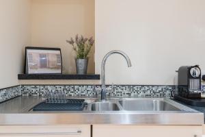 a kitchen with a sink and a counter top at 138 North Street - luxury 2 bed 2 bath with secret garden, summerhouse, putting green in St Andrews
