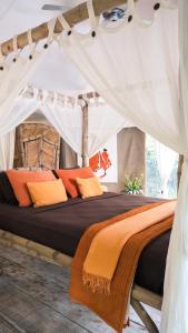 a bedroom with a bed in a tent at Sandat Glamping Tents in Ubud