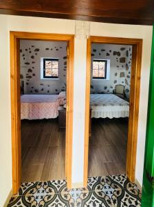 a room with two beds and two windows at Casa Abuela Inés in Puerto del Rosario