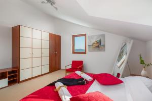 a bedroom with a large bed and a red chair at Luxury Villa Bella Vista with Swimming Pool in Betina