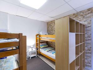 a room with two bunk beds and a brick wall at Appartement 8 places à Gourette, 3 chambres, proche pistes - FR-1-400-50 in Gourette