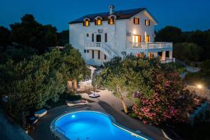 an image of a house with a swimming pool in front of it at Luxury Villa Bella Vista with Swimming Pool in Betina +106 photos
