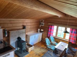 uma cozinha e sala de estar com um fogão numa cabina em Atnasjø Kafe AS em Sollia