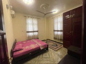 1 dormitorio con cama y techo en Furaha Suite Apartment, en Mwana Kerekwe