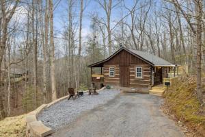 a log cabin in the middle of the woods at Smoky Speakeasy 2 Cabins 2 Hot Tubs and Private Pool in Gatlinburg