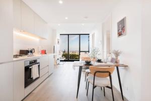 a kitchen with a table and chairs in a room at Modern 1BR Apt in Southbank #Australia108#AU4408 in Melbourne