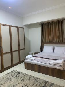 a bedroom with a large bed with a wooden headboard at Comfort suite in Cairo
