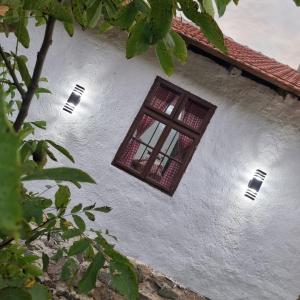 a window on the side of a white building at Apartmani kod Kmeta in Janja