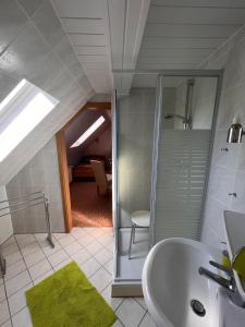 a bathroom with a glass shower and a sink at Pension 2 Ferienhof Hanstorf in Satow