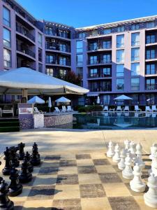 a giant chessboard in front of a large building at Rainbow 3 Sunny Beach Topo Apartment in Sunny Beach
