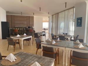 a dining room with tables and chairs and a room with a unintention at Villa La Falaise in Oualidia
