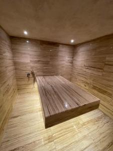 a large wooden room with a bed on a wooden floor at Villa La Falaise in Oualidia