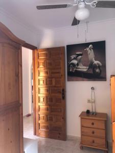 a room with a door with a scooter on the wall at Paraíso in Cumbre del Sol
