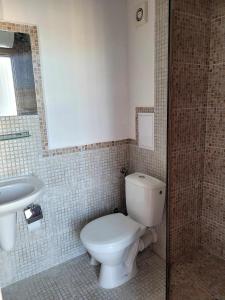 a bathroom with a toilet and a sink at Rainbow 3 Sunny Beach Topo Apartment in Sunny Beach