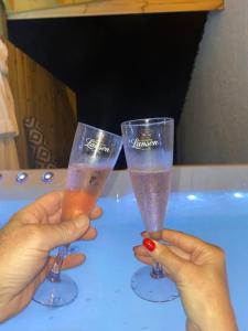 two hands holding two glasses of champagne on a table at Lanfine View 1 at Loudoun Mains with Hot Tub in Newmilns