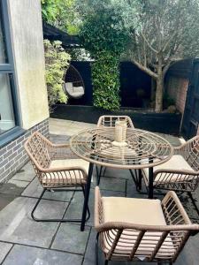 a patio with a table and two chairs and a table and chairs at Private garden oasis in central Bristol in Bristol