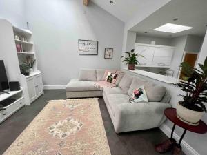 a living room with a couch and a rug at Private garden oasis in central Bristol in Bristol