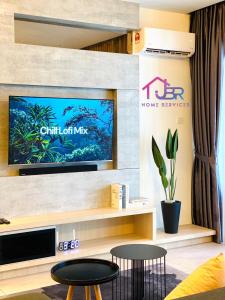 a living room with a tv on a wall at JBR LUXURY HOMESTAY-ATLANTIS RESIDENCES-Near Jonker Walk-City Area-Netflix in Melaka