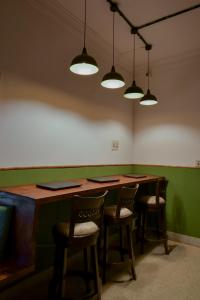 a room with a table with chairs and lights at Snore Summore, Hostel in Koramangala in Bangalore