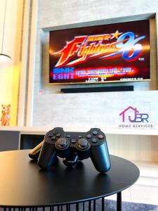 two video game controllers sitting on top of a table at JBR LUXURY HOMESTAY-ATLANTIS RESIDENCES-Near Jonker Walk-City Area-Netflix in Melaka