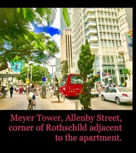 a city street with cars and a red van at C.B.O. Tel Aviv 117 Allenby St. in Tel Aviv