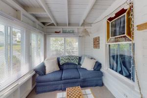 a blue couch in a room with a window at Cabin at the Beach in Old Orchard Beach