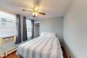 a bedroom with a bed and a ceiling fan at Cabin at the Beach in Old Orchard Beach