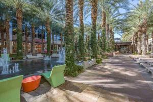 a park with a fountain with palm trees and benches at Kierland Greens #2122 in Scottsdale